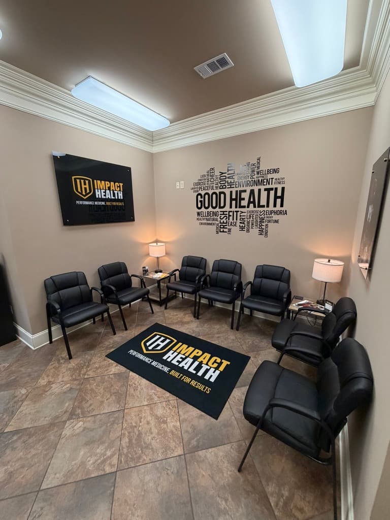 Impact Health Oxford lobby, framed Impact Health sign on charcoal wall, GOOD HEALTH wellness mural, leather waiting chairs around branded floor mat