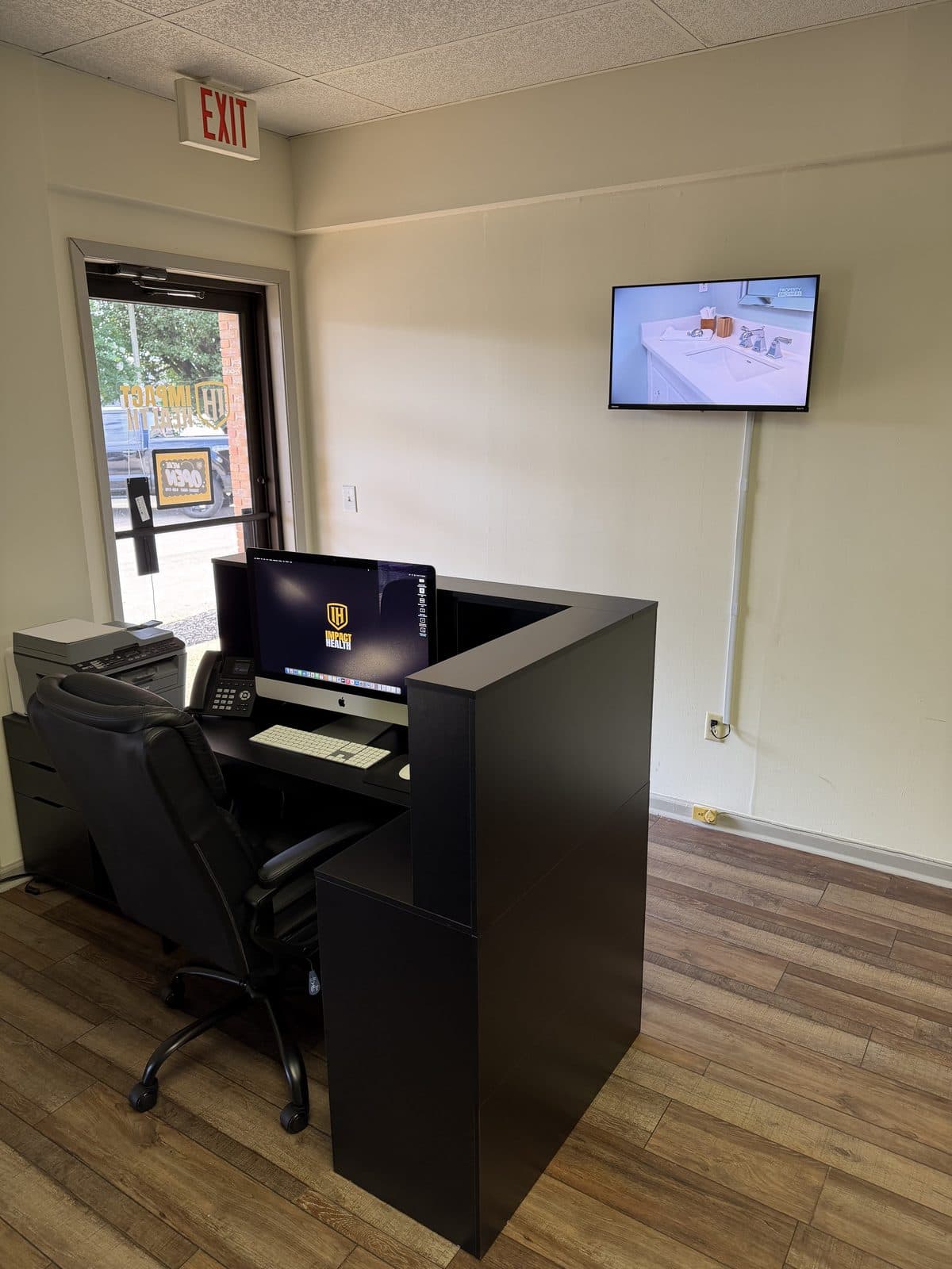 Front desk and check-in station at Impact Health Tupelo